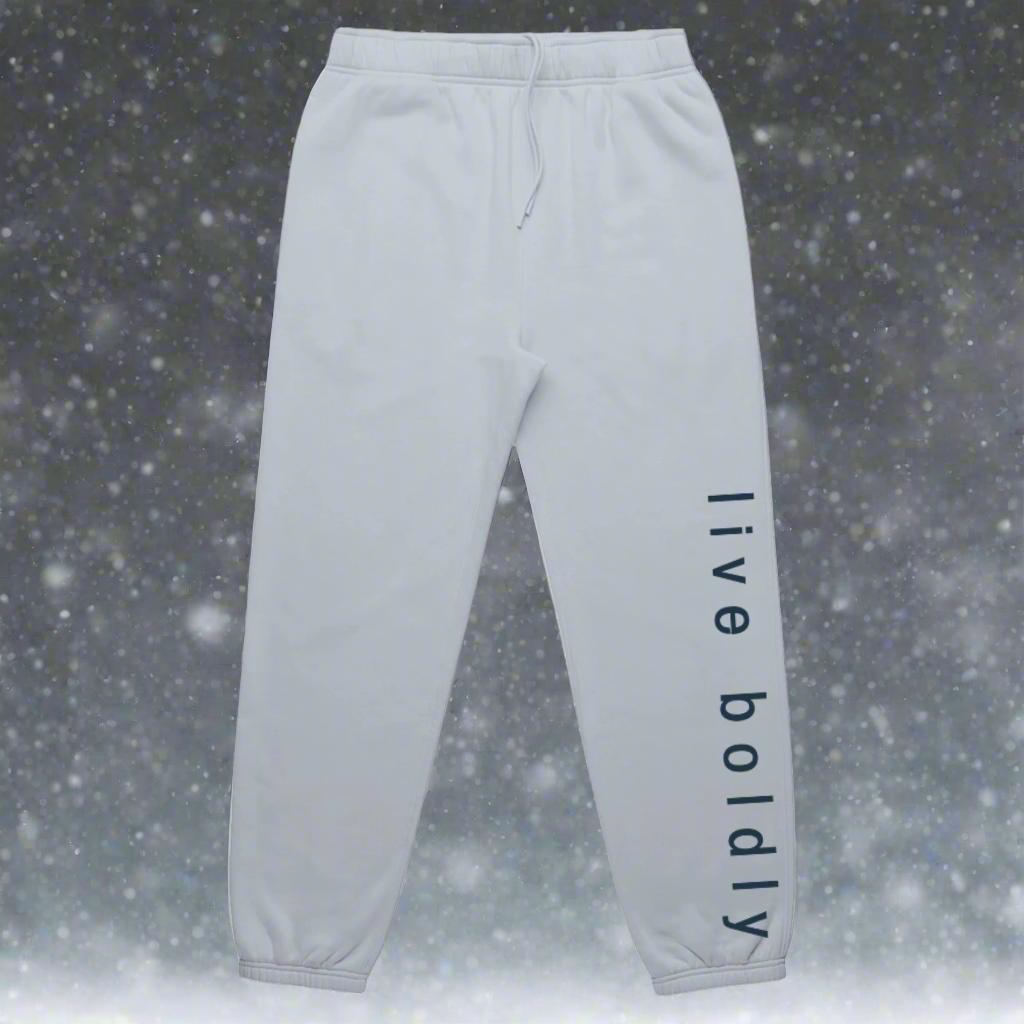 MOVE. MAKE. BLOOM. Bold & Free Relax Track Pants from the Bold & Free Winter Collection in powder, showing the phrase "live boldly" on the left side of the leg